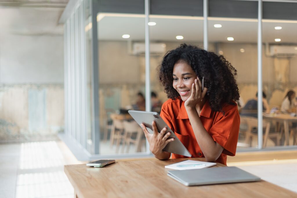 Young,Happy,Smiling,African,American,Woman,Using,On,Digital,Tablet